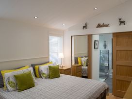 A bedroom with a bed and mirror at The Royal in Waltham