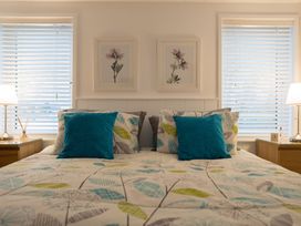 A bedroom with a bed and nightstands at The Royal in Waltham