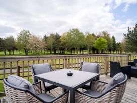 An outdoor seating area with a table and chairs at The View in Waltham