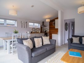 A living room with a sofa and dining area at The View in Waltham