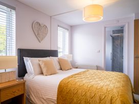 A bedroom with a bed and lamp at The View in Waltham