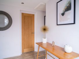 A hallway with a mirror and table at The View in Waltham