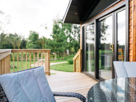 An outdoor space with a table and chairs on the decking at Macosi in Waltham