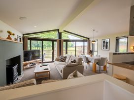 A living room with a sofa and dining area at Macosi in Waltham
