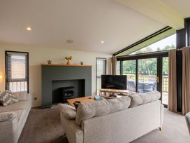 A living room with a fireplace and television at Macosi in Waltham