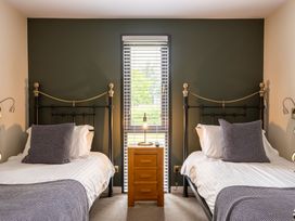 A bedroom with two beds and a nightstand at Macosi in Waltham