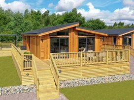 A wooden cabin with decking and steps at The Luxury Retreat in Waltham