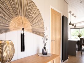 An entryway with decorative fan and table at The Luxury Retreat in Waltham