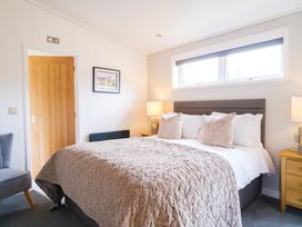 A bedroom with a bed and bedside tables at The Luxury Retreat in Waltham