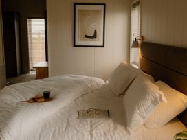 A bedroom with a bed, coffee, and glasses at Luxury Boutique Retreat Spa in Waltham