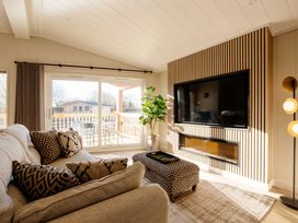 A living room with a sofa and television at Luxury Boutique Retreat in Waltham