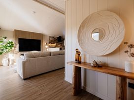 A living room with a sofa and television at Luxury Boutique Retreat in Waltham