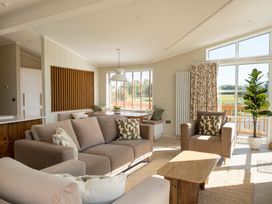 A living room with two sofas and a dining table at Exclusive Aura Spa Waltham