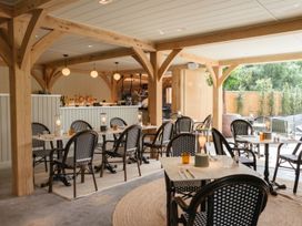 A dining room with tables and chairs at Exclusive Aura Spa in Waltham