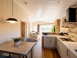 A kitchen with a table and chairs at Luxury Boutique Retreat Pet in Waltham