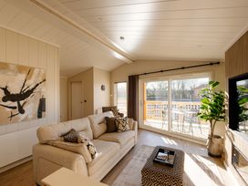 A living room with sofa and sliding door at Luxury Boutique Retreat Pet in Waltham