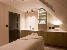 A spa room with a massage table and shelves at Luxury Boutique Retreat Pet in Waltham