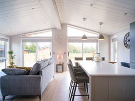 A living room with a sofa and kitchen island at Marrakech in Waltham