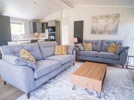 A living room with grey sofas and a wooden coffee table at Marrakech in Waltham