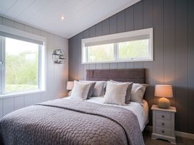 A bedroom with a bed and windows at Marrakech in Waltham