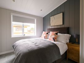 A bedroom with a bed, pillows, and a lamp at Marrakech in Waltham