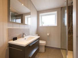 A bathroom with a sink, toilet and shower at Marrakech in Waltham