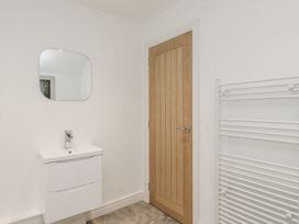 A bathroom with a sink and mirror at Ty'n Lon in Pwllheli