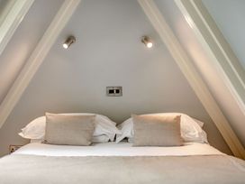 A bedroom with a bed and pillows at St Ives Studio Spa in Praze-An-Beeble