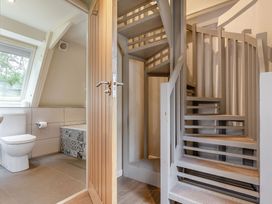 A bathroom with a toilet and staircase at St Ives Studio Spa in Praze-An-Beeble