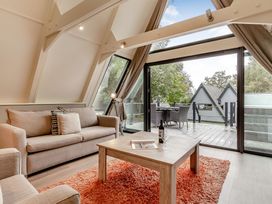 A living room with a couch and coffee table at St Ives Studio Spa in Praze-An-Beeble