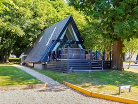 A house with a deck and trees at St Ives Lodge 2 Spa Praze-An-Beeble
