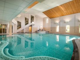 A pool area with a swimming pool and loungers at St Ives Lodge 2 Spa Praze-An-Beeble