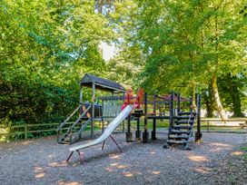 A playground with a slide and climbing structure at St Ives Lodge 2 Spa in Praze-An-Beeble