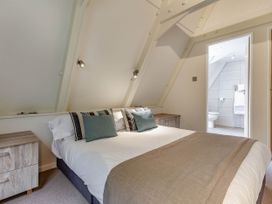 A bedroom with a bed and adjoining bathroom at St Ives Lodge 3 Spa in Praze-An-Beeble