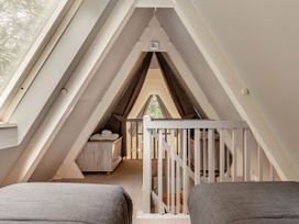 An attic with a view and a railing at St Ives Lodge 3 Spa, Praze-An-Beeble