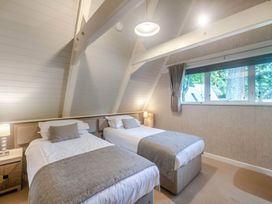 A bedroom with twin beds and a window at Glass Lodge in Praze-An-Beeble