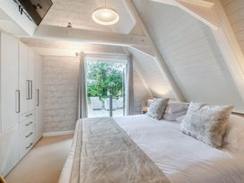 A bedroom with a bed and closet at Glass Lodge in Praze-An-Beeble