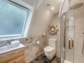 A bathroom featuring a shower, toilet, and sink at Glass Lodge in Praze-An-Beeble