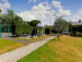 A garden with a pavilion and chess set at Glass Lodge in Praze-An-Beeble