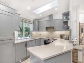 A kitchen with cabinets and a countertop at Aubyn Lodge Spa in Praze-An-Beeble