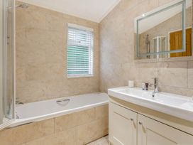 A bathroom with a bathtub and sink at Aubyn Lodge Spa Praze-An-Beeble