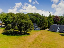 A view of cabins and trees in a natural setting at Aubyn Lodge Spa, Praze-An-Beeble