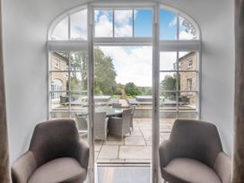A dining area with chairs and a view of the patio at Coach House Praze-An-Beeble