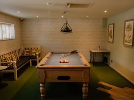 A snug with a pool table and seating at Coach House in Praze-An-Beeble