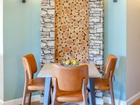 A dining room with a table and chairs at The Treehouse in Praze-An-Beeble
