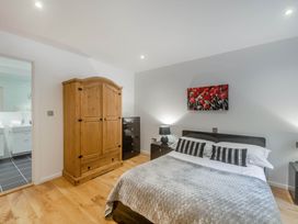 A bedroom with a bed and wardrobe at Cornwall Lodge Spa in Praze-An-Beeble