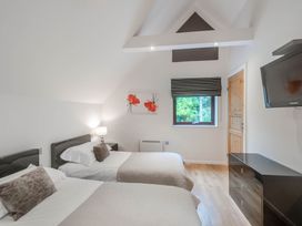 A bedroom with two beds and a window at Cornwall Lodge Spa in Praze-An-Beeble