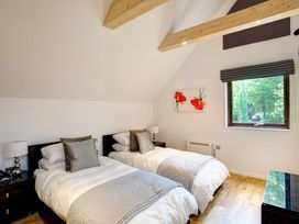 A bedroom with two twin beds and a window at Cornwall Lodge Spa in Praze-An-Beeble