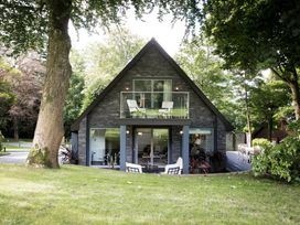 A house with a balcony and deck at St Austell Lodge Spa in Praze-An-Beeble