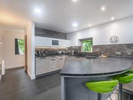 A kitchen with a countertop and stools at St Austell Lodge Spa, Praze-An-Beeble